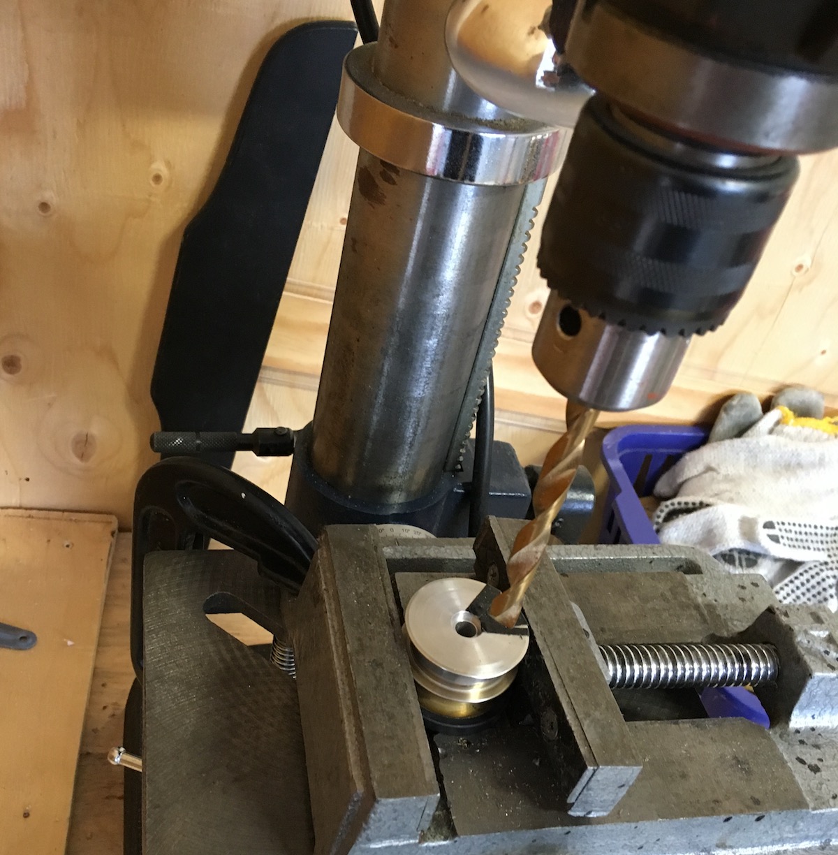 Drive pulley under a drill press to make a hole for a magnet